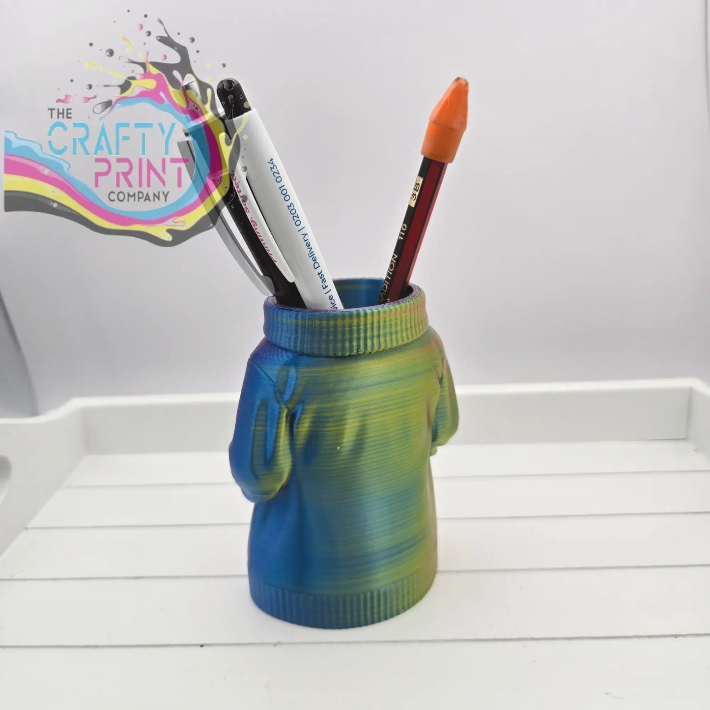 Colorful 3d printed jumper pen pot shaped like a sweater with blue and green gradient hues for desk organization