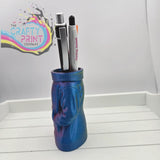 A vibrant blue and purple 3d printed jumper pen pot shaped like a sweater figure for desk organization