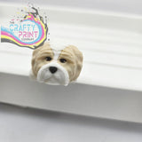 Beige and white glossy bulldog-shaped bookend paired with 3d printed shih tzu dog articulated flexi keyring fidget