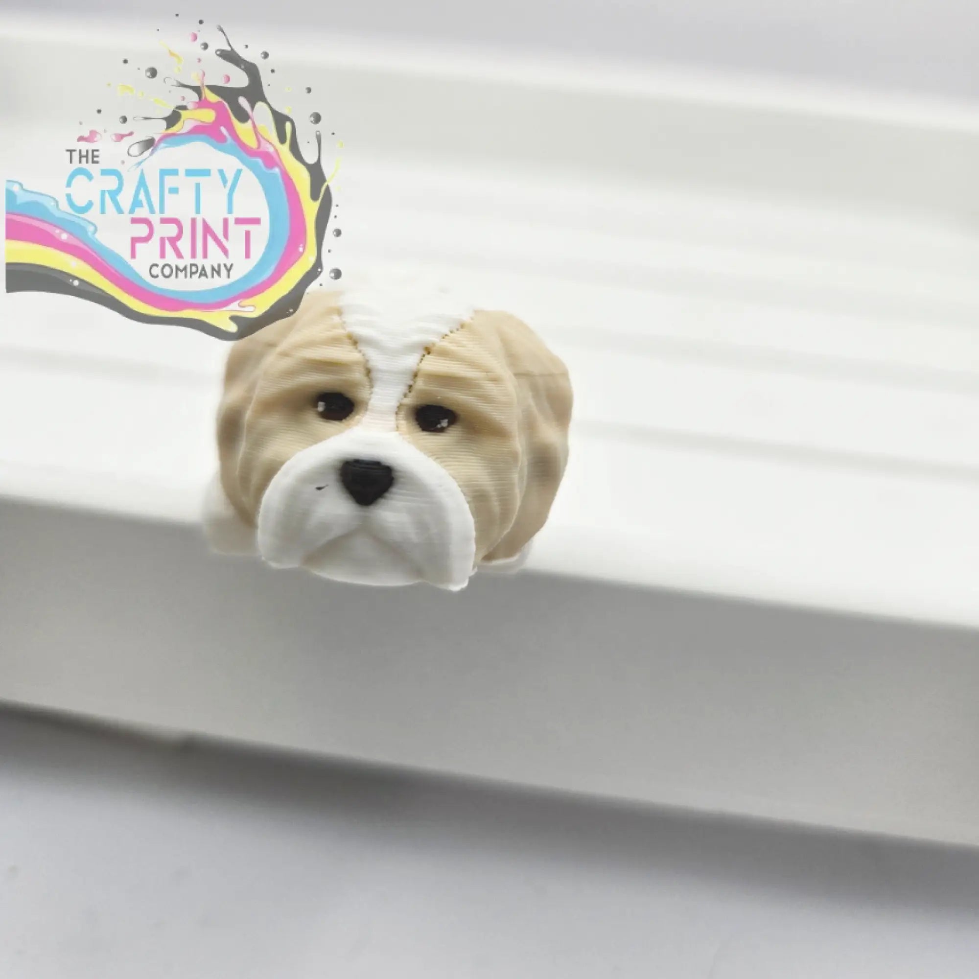 Beige and white glossy bulldog-shaped bookend paired with 3d printed shih tzu dog articulated flexi keyring fidget