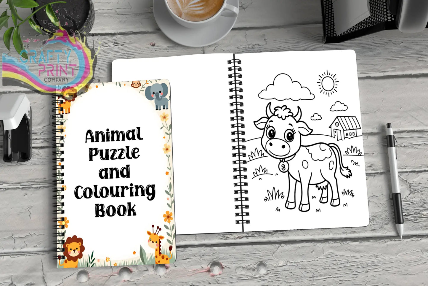 White spiral-bound animal puzzle and coloring activity book with colorful lion elephant giraffe and cow illustrations for kids