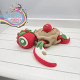 Whimsical red and beige apple pie sea turtle flexi fidget toy with green leaf accents and articulated design