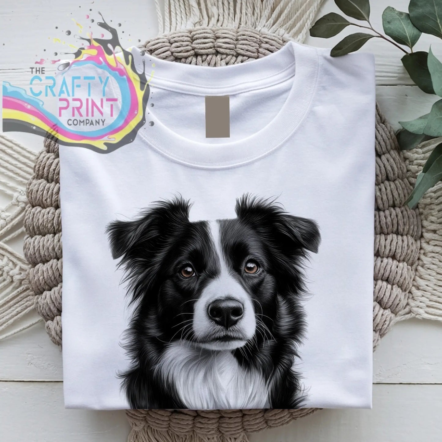 White cotton t-shirt featuring a detailed black and white border collie pencil drawing on the front