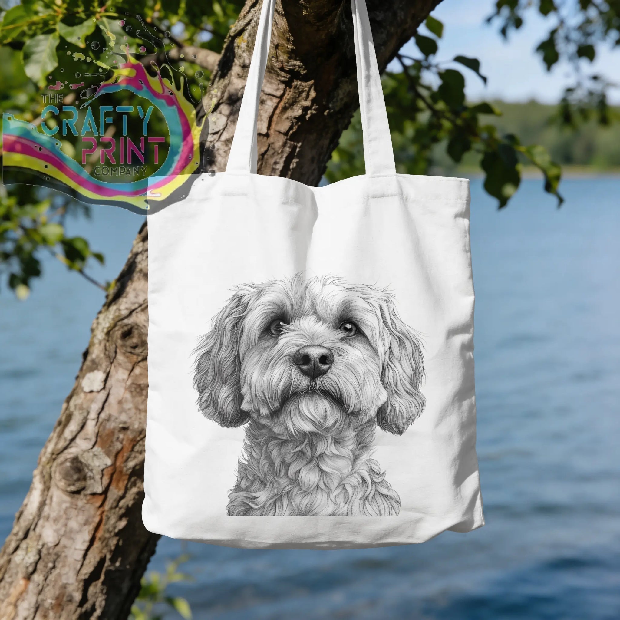 White canvas tote bag with a detailed black and white cockapoo pencil drawing of a fluffy dog face