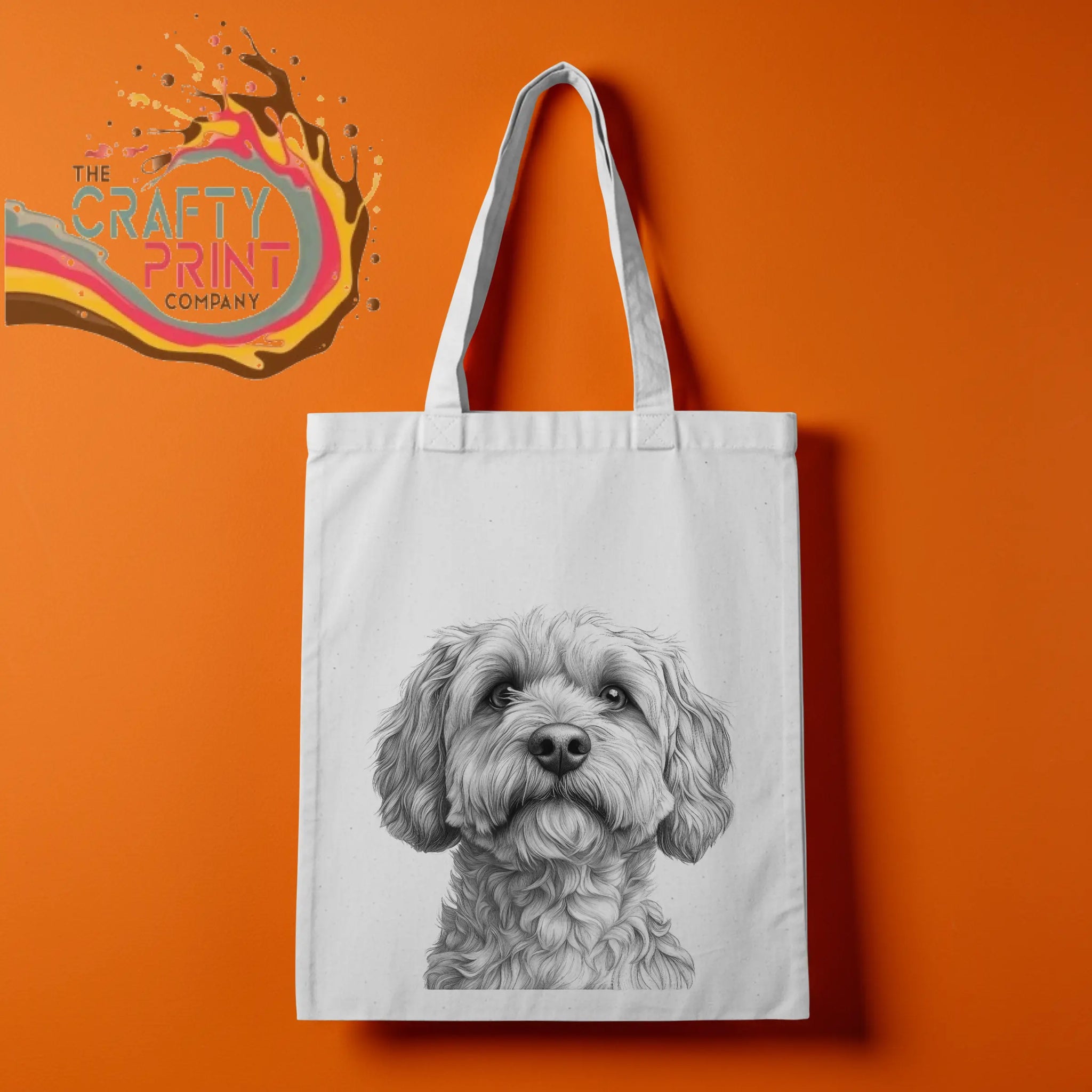 White canvas tote bag featuring a detailed cockapoo pencil drawing of a fluffy dog face for reusable use