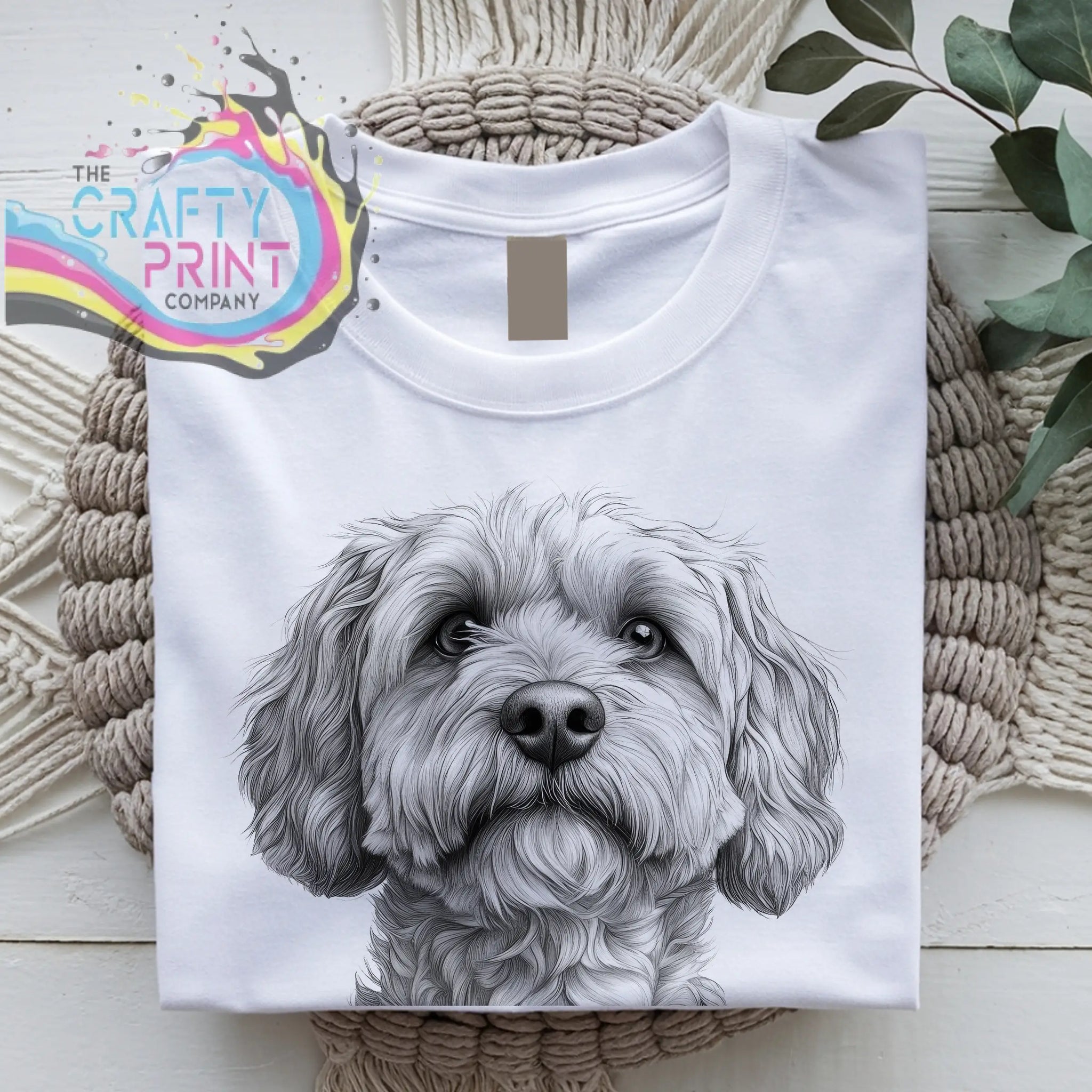 White cotton t-shirt featuring a detailed cockapoo pencil drawing of a fluffy dog face in black and white