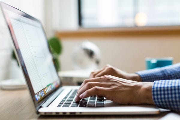 Laptop with hands typing