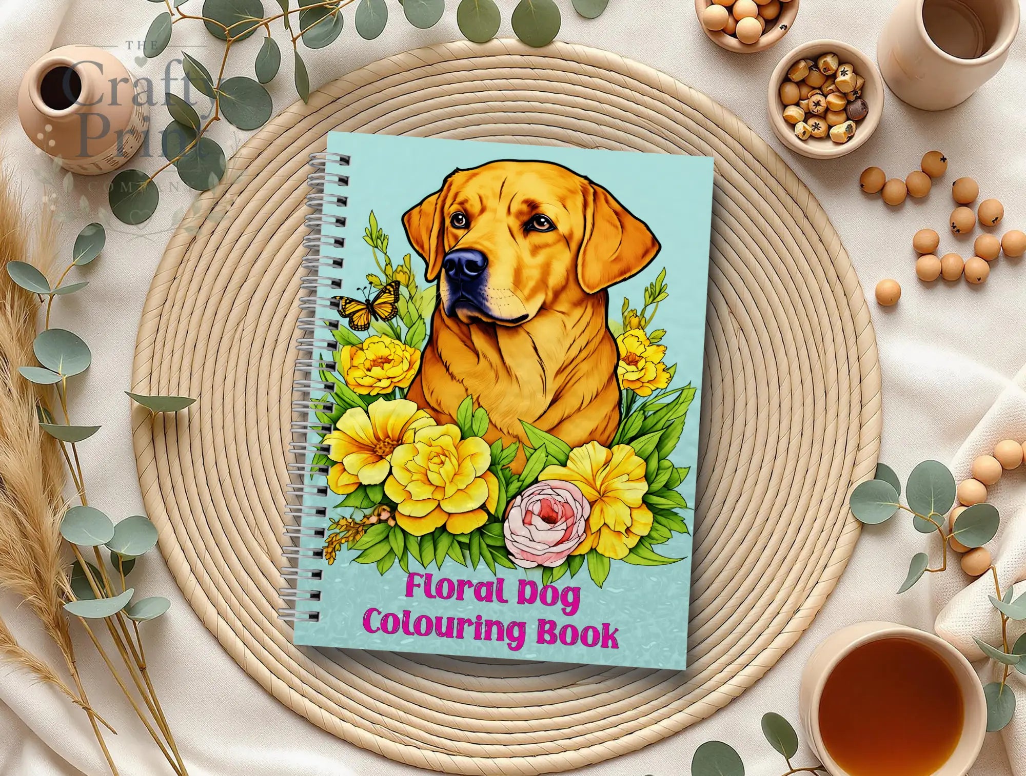 A spiral-bound floral dog coloring book with a golden labrador and vibrant flowers on a light blue cover for relaxation
