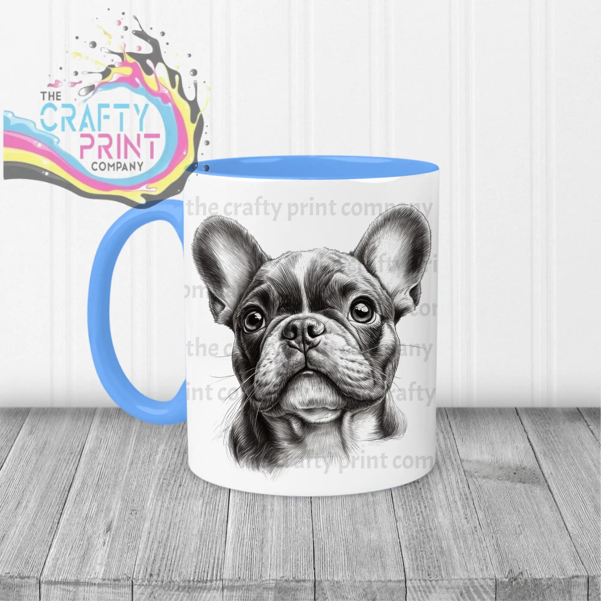White ceramic mug with blue handle and interior featuring a detailed black and white french bulldog pencil drawing face