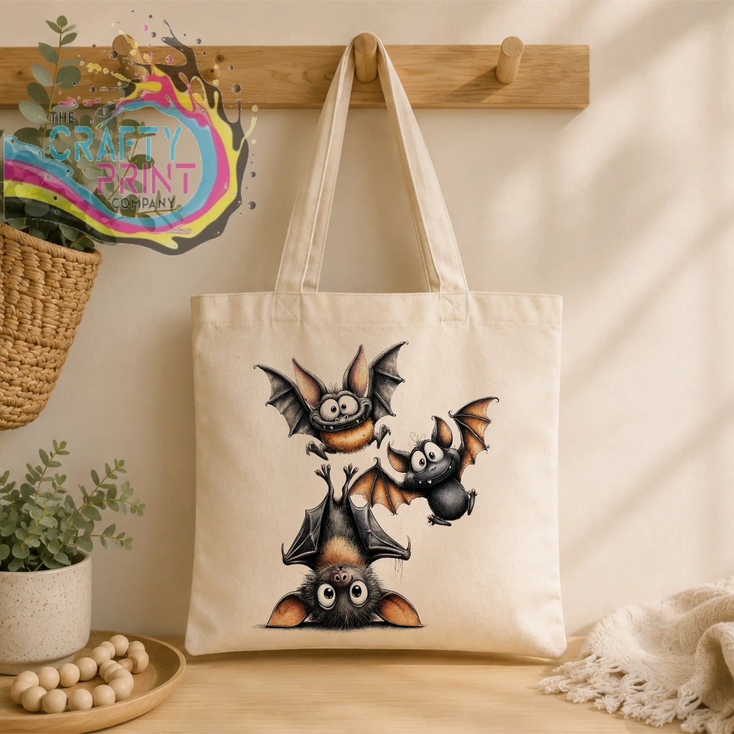 Cream-colored canvas tote bag with funny bats illustration in black brown and orange made of durable polyester