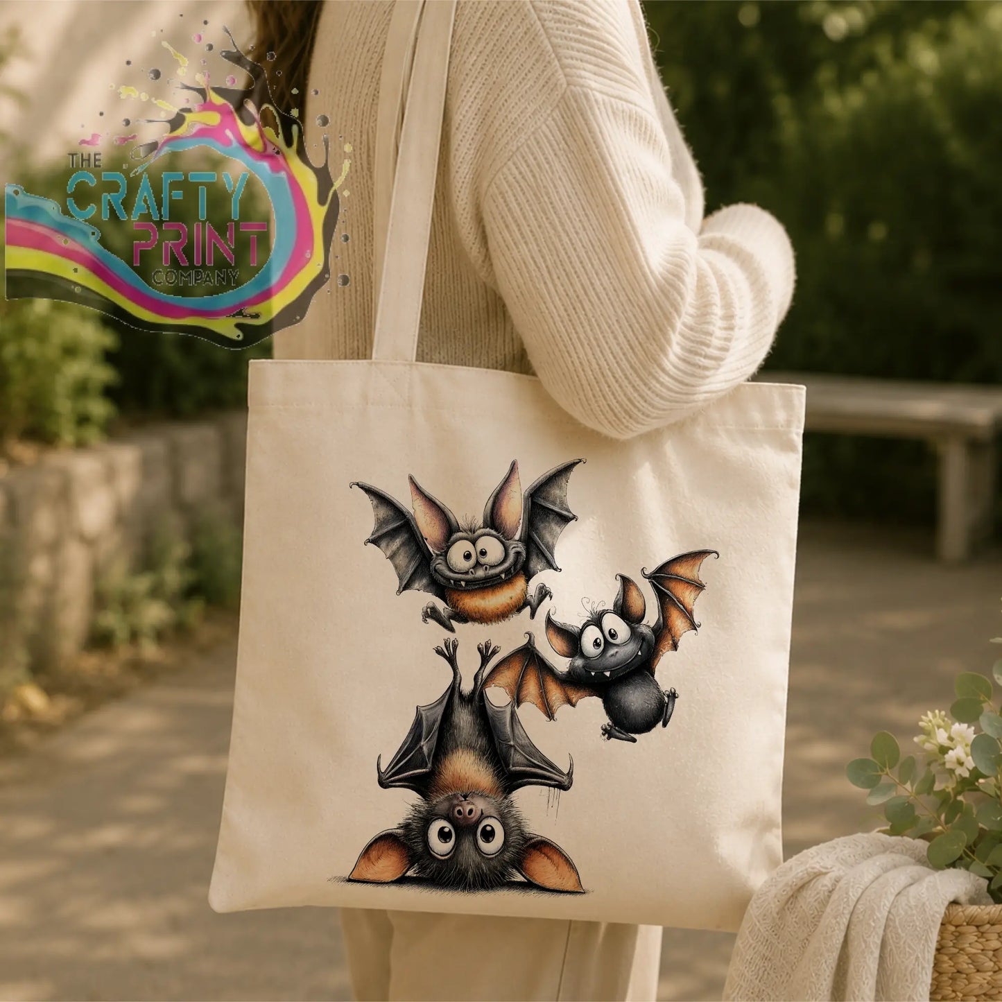 Cream-colored durable polyester tote bag with funny bats illustration in black brown and gray tones and expressive eyes