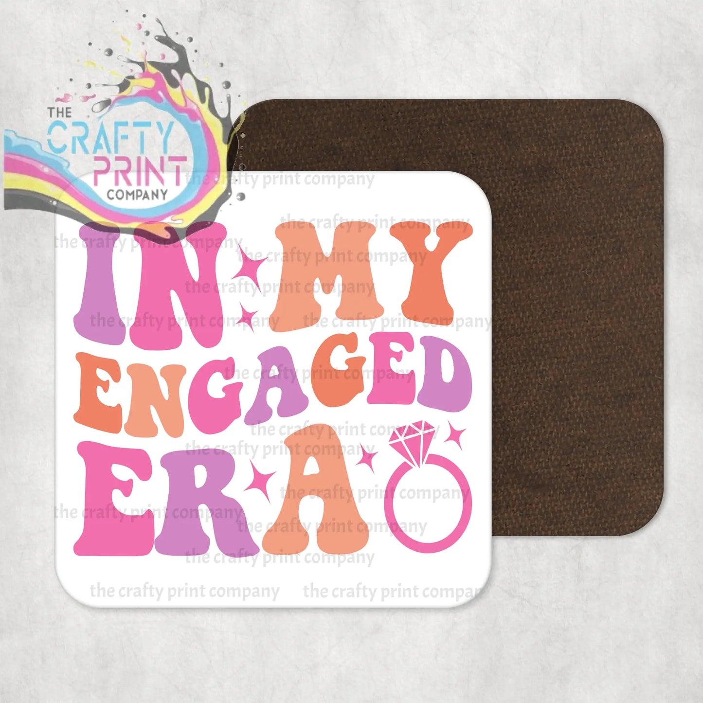 White square coaster with high gloss finish featuring colorful in my engaged era text and diamond ring for protecting surfaces