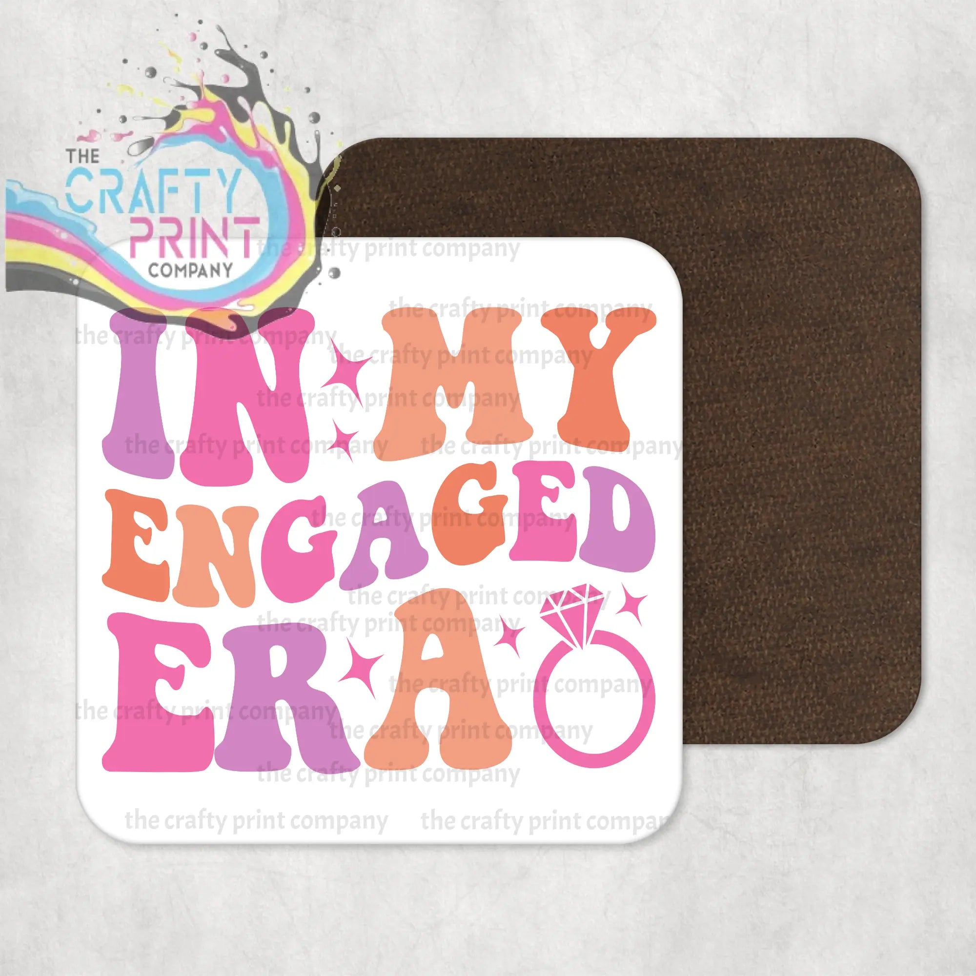 White square coaster with high gloss finish featuring colorful in my engaged era text and diamond ring for protecting surfaces