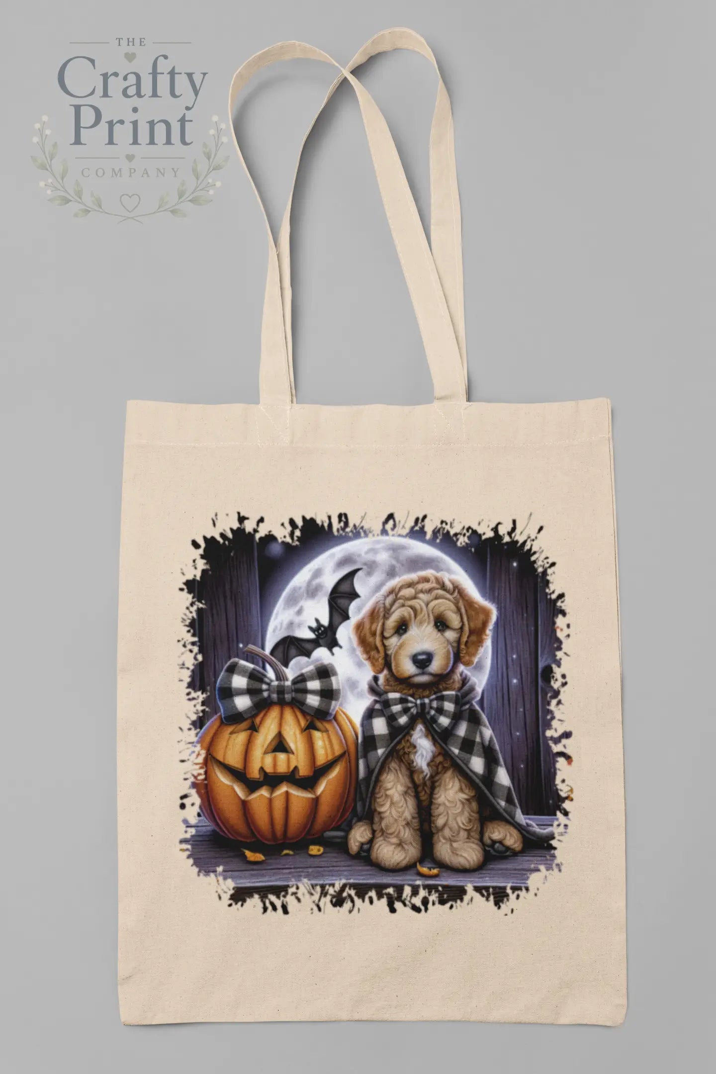 Beige labradoodle halloween cotton tote bag featuring a golden retriever puppy with a pumpkin and full moon background