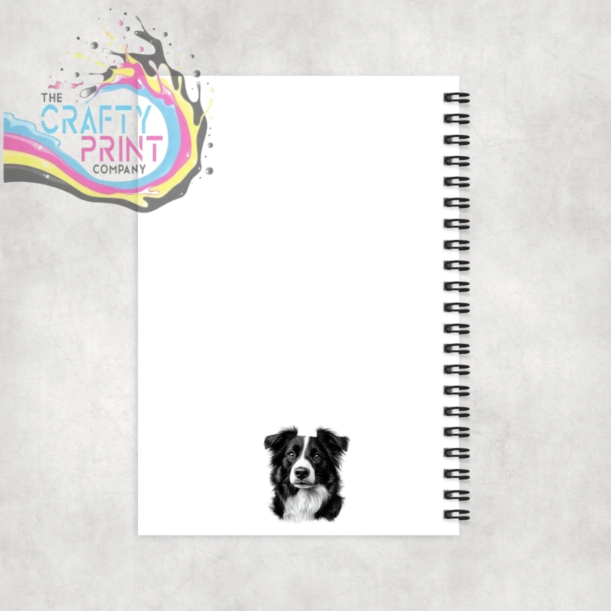 White spiral notebook with a personalised border collie pencil drawing of the dog face on the front cover