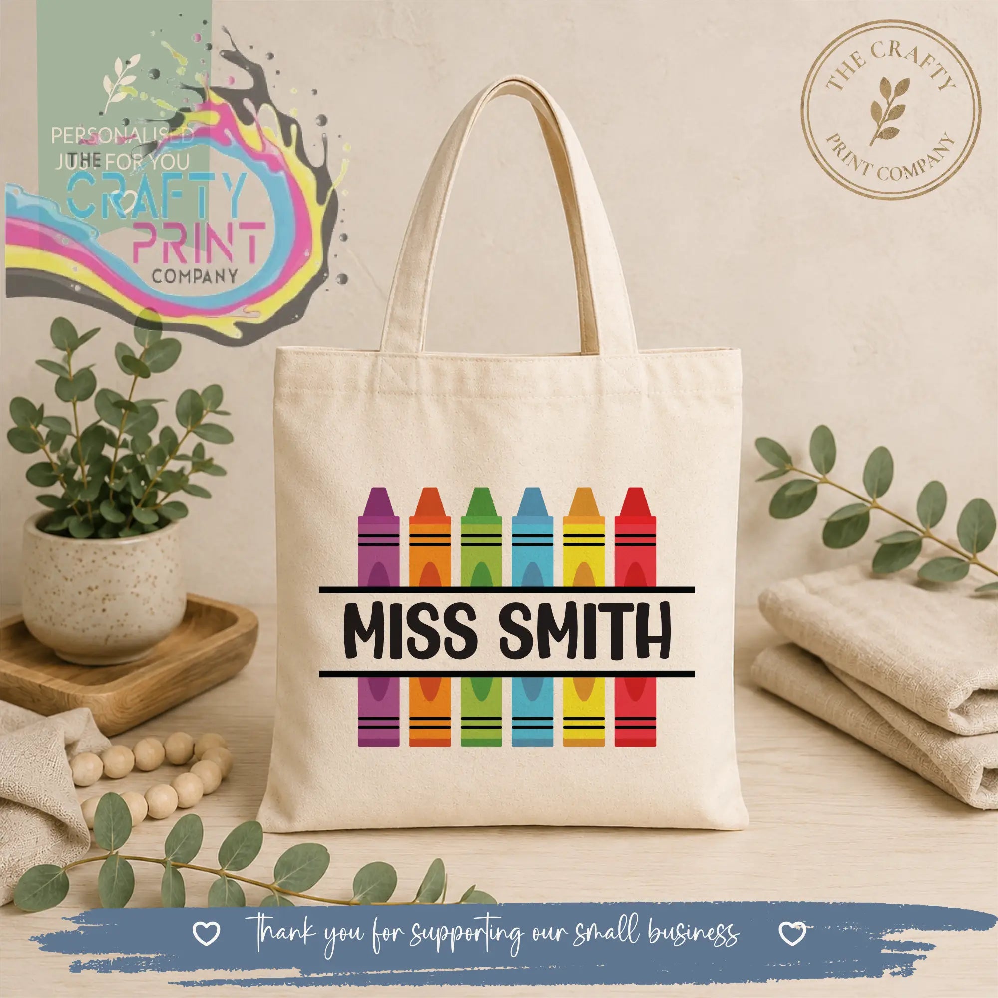 Cream-colored canvas personalised crayon teacher tote bag with rainbow design and miss smith name in bold black letters