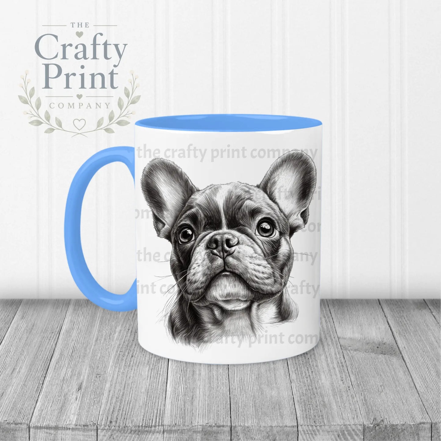 White ceramic mug with blue handle and interior featuring a detailed black and white french bulldog pencil drawing face