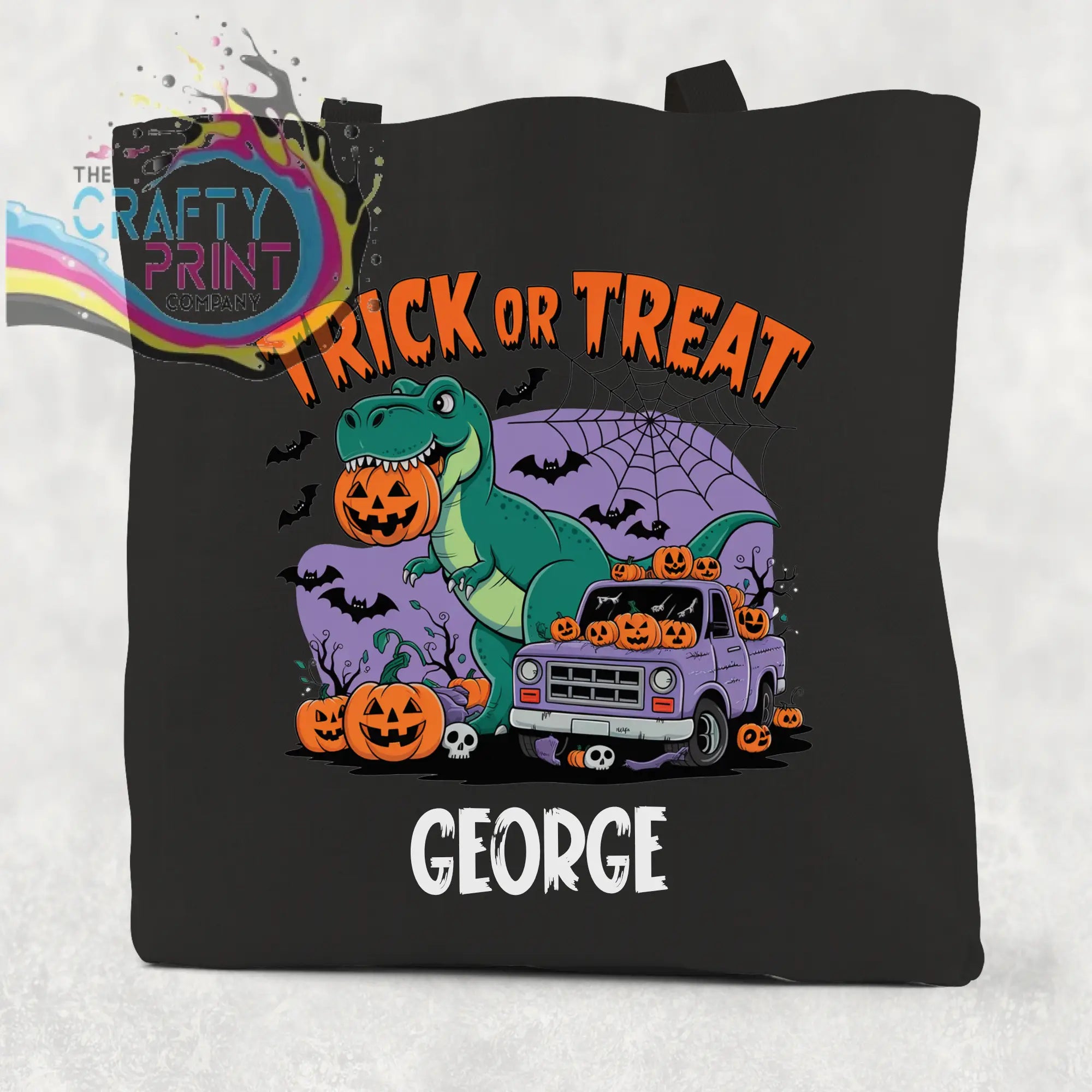Black canvas personalised trick or treat dinosaur cotton tote bag with green t-rex holding pumpkin and halloween design