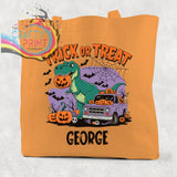 Orange canvas personalised trick or treat dinosaur cotton tote bag with halloween graphic and pumpkins by george