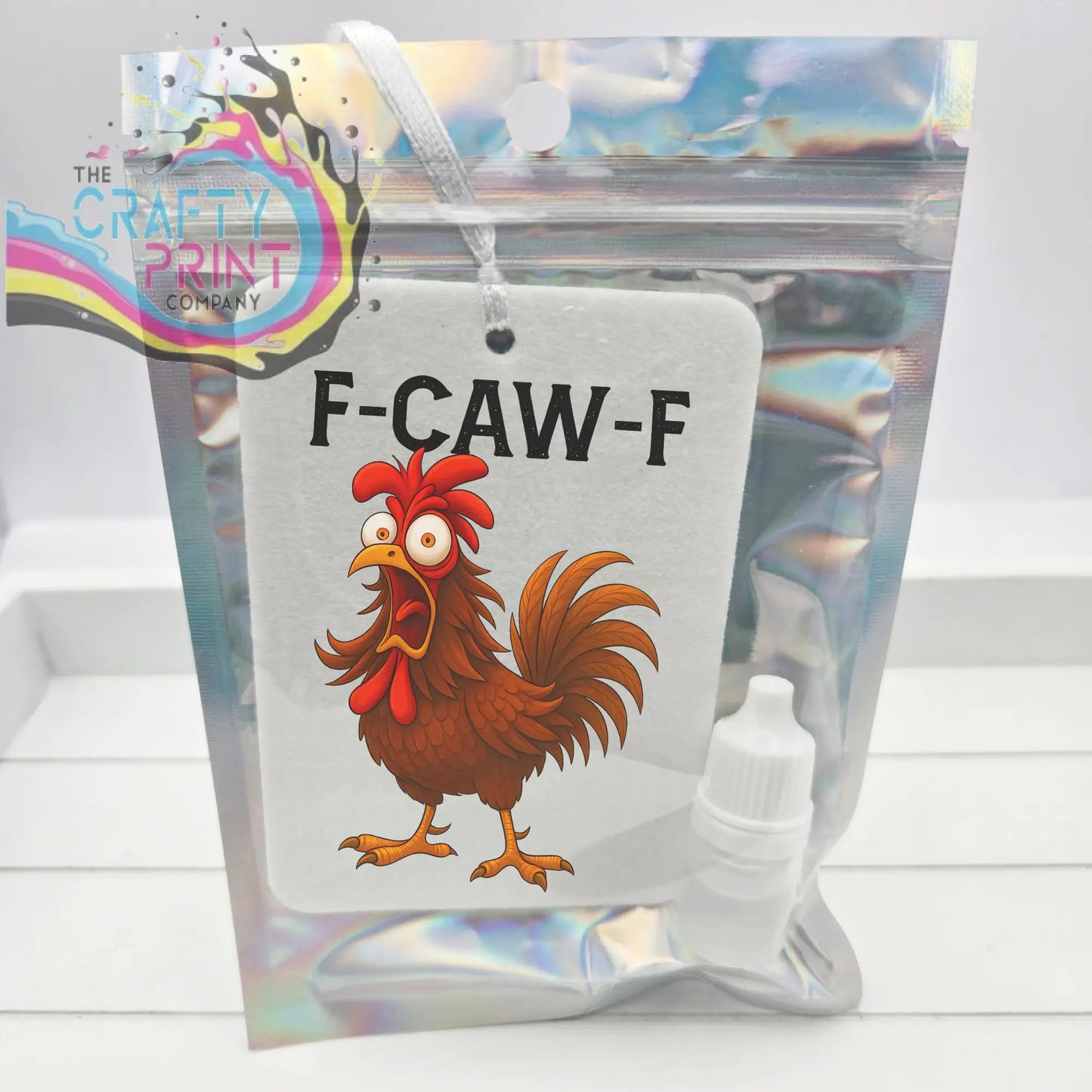 White rectangular car air freshener featuring a cartoon rooster with red comb and tail and black f-caw-f text for car air use