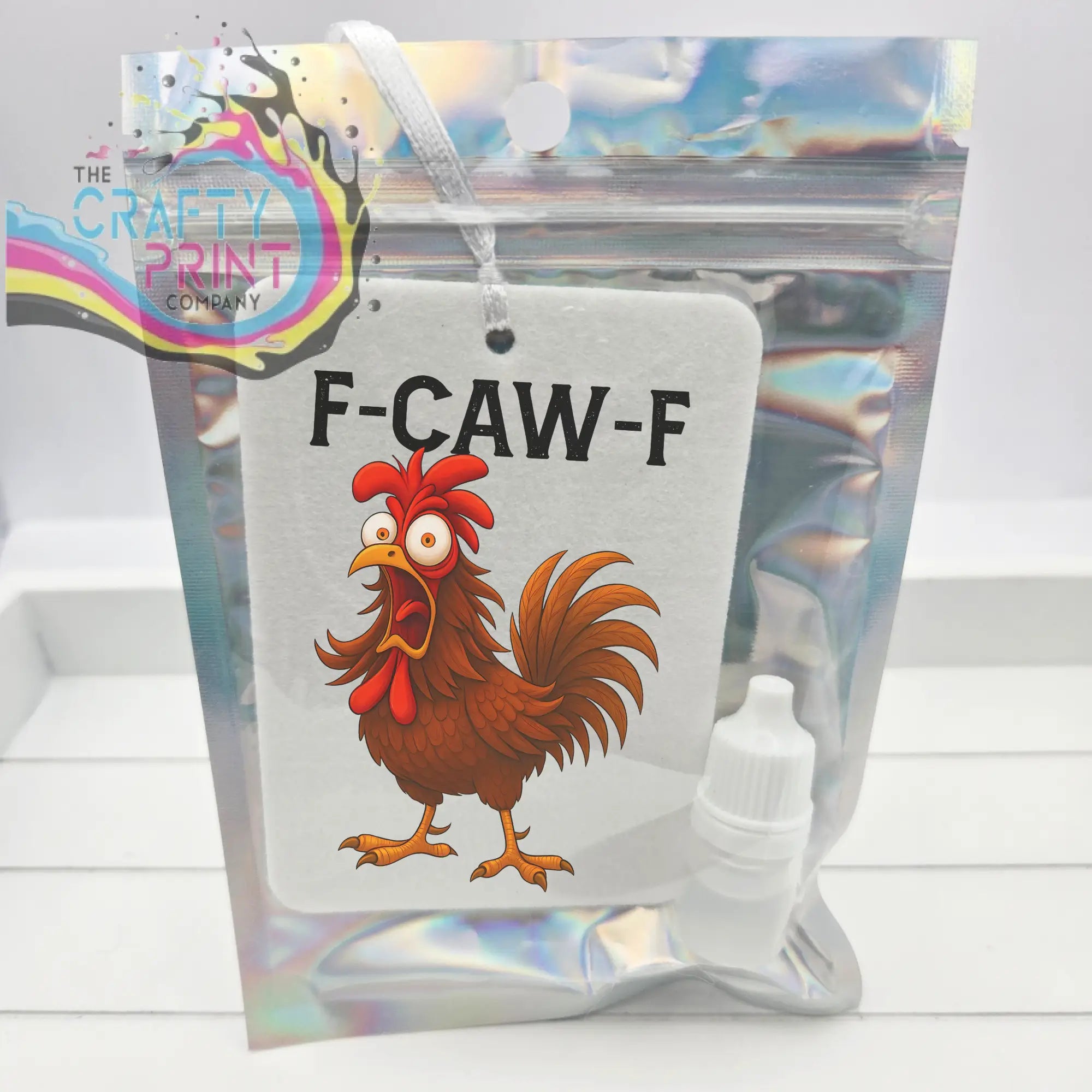 White rectangular car air freshener featuring a cartoon rooster with red comb and tail and black f-caw-f text for car air use