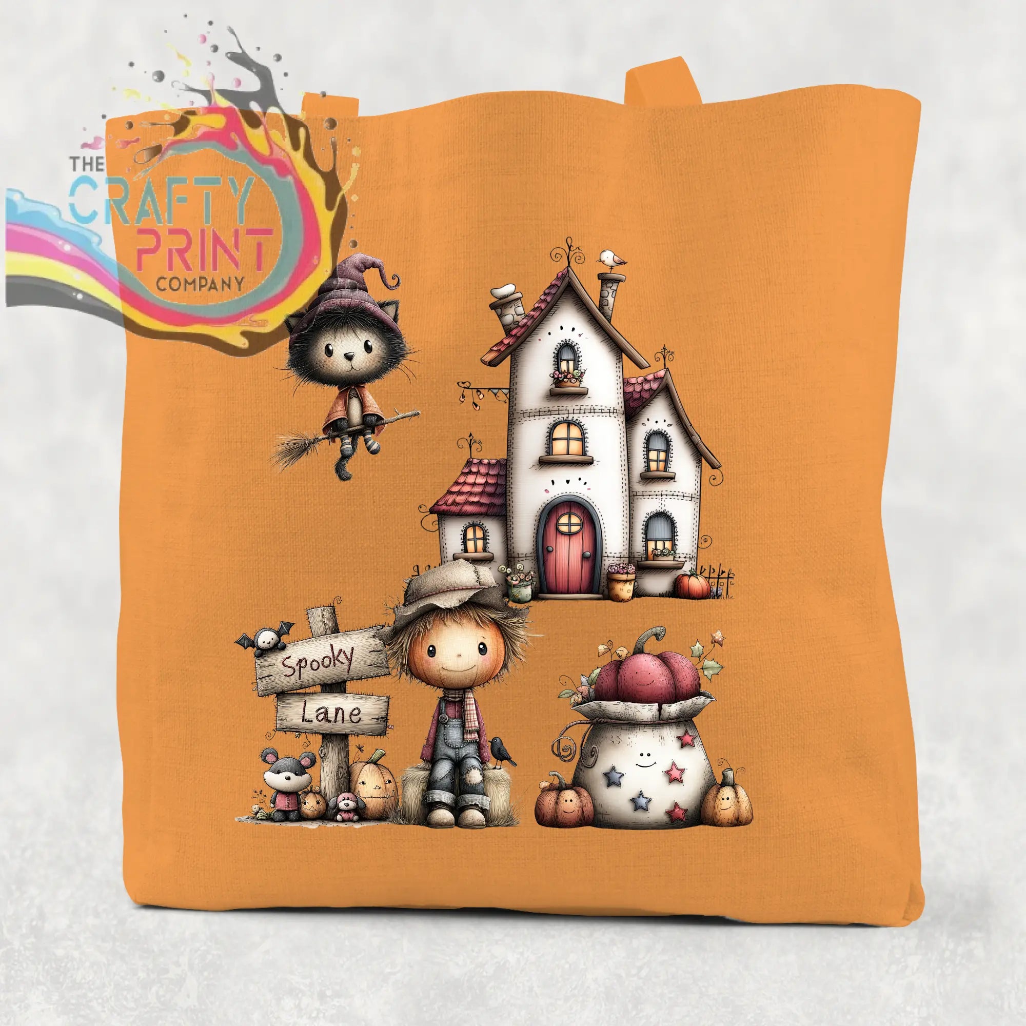 Orange cotton re-usable tote bag with spooky lane halloween design featuring a witch cat haunted house and scarecrow