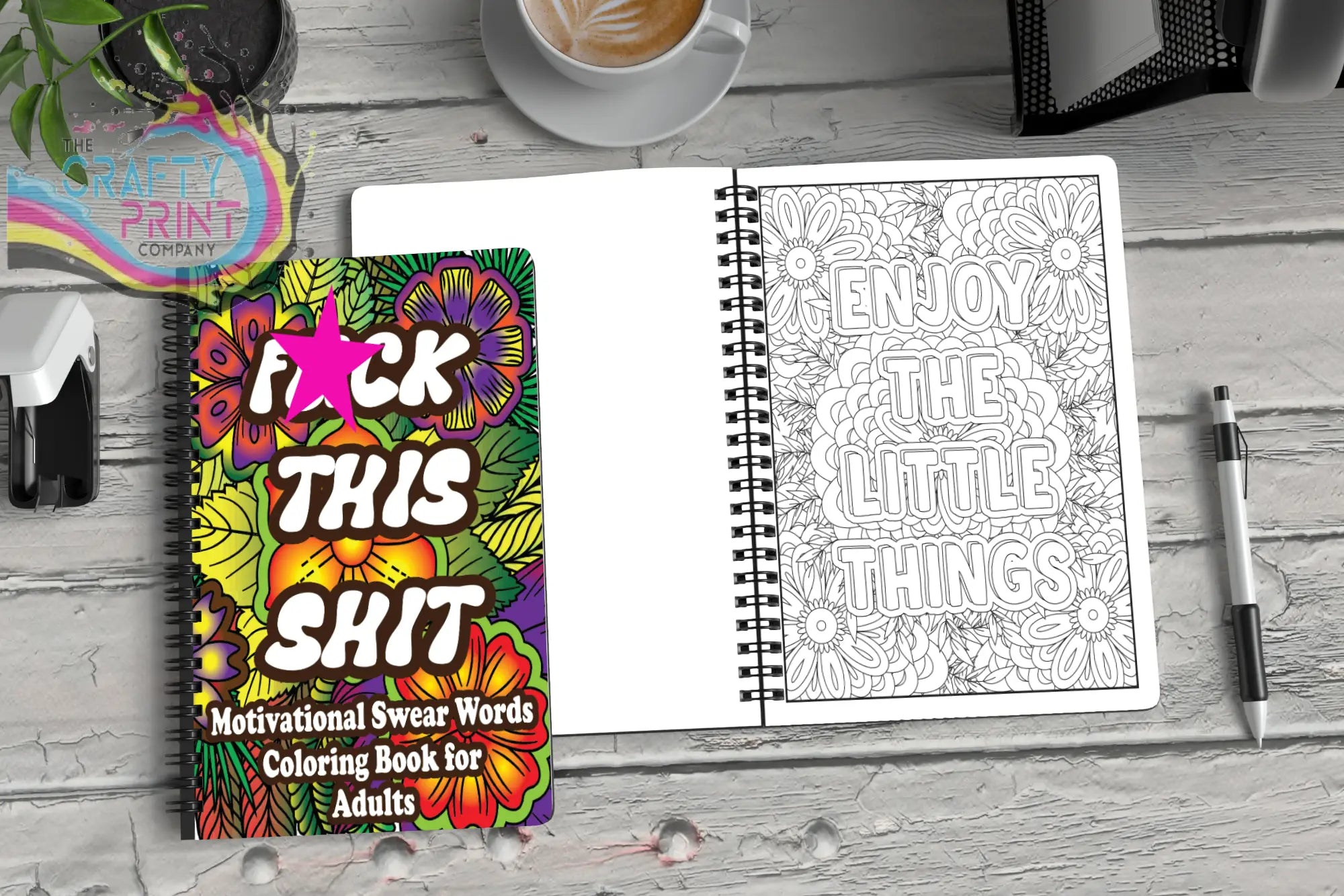 Vibrant floral-covered spiral-bound swear word colouring book for adults with motivational stress relief phrases and bold text