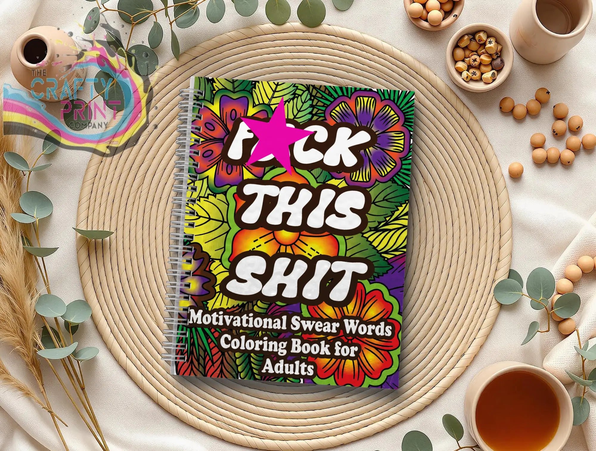 Vibrant floral-patterned swear word colouring book for adults with motivational designs and spiral binding for stress relief