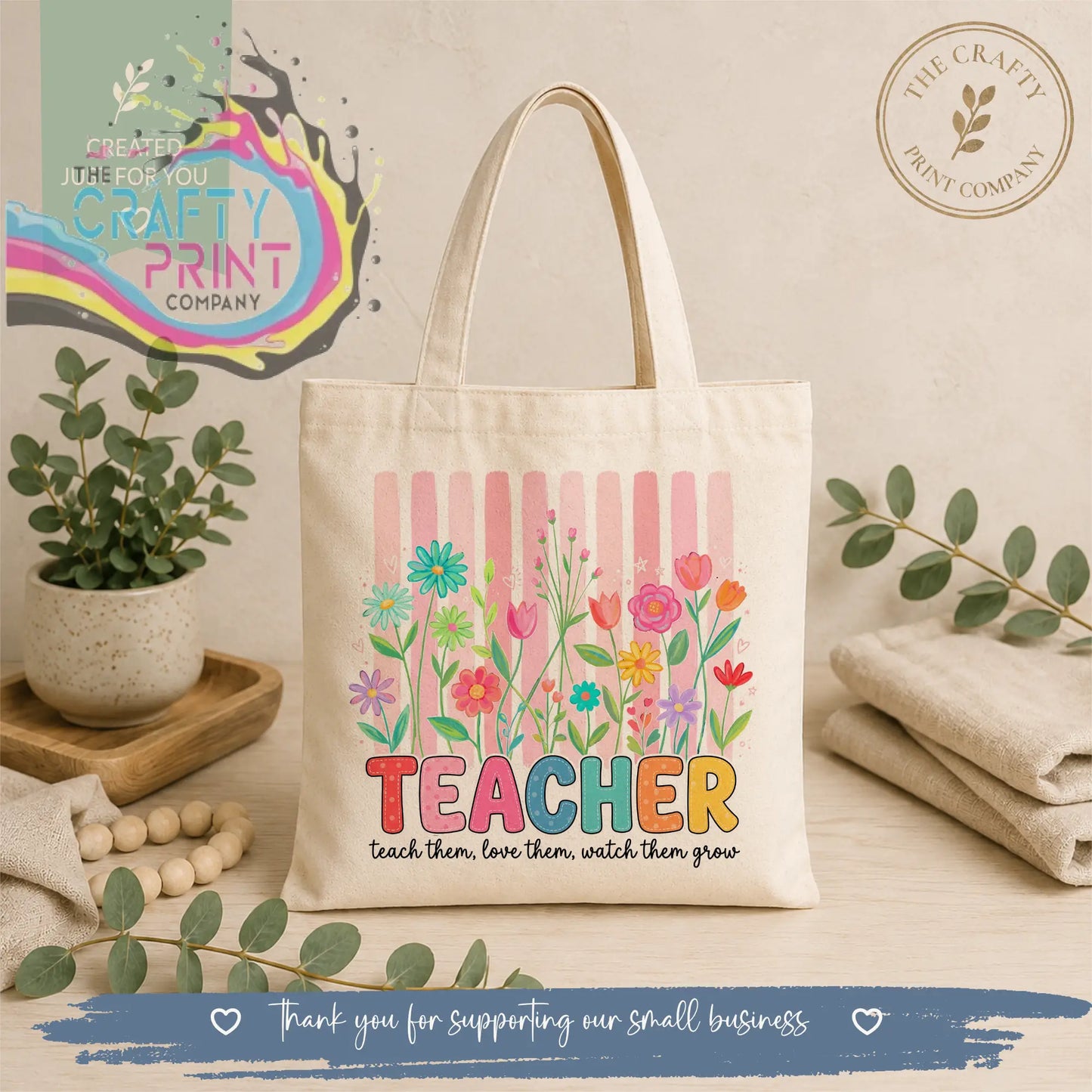 Cream-colored canvas re-usable tote bag with vibrant floral design and colorful teacher text with motivational phrase