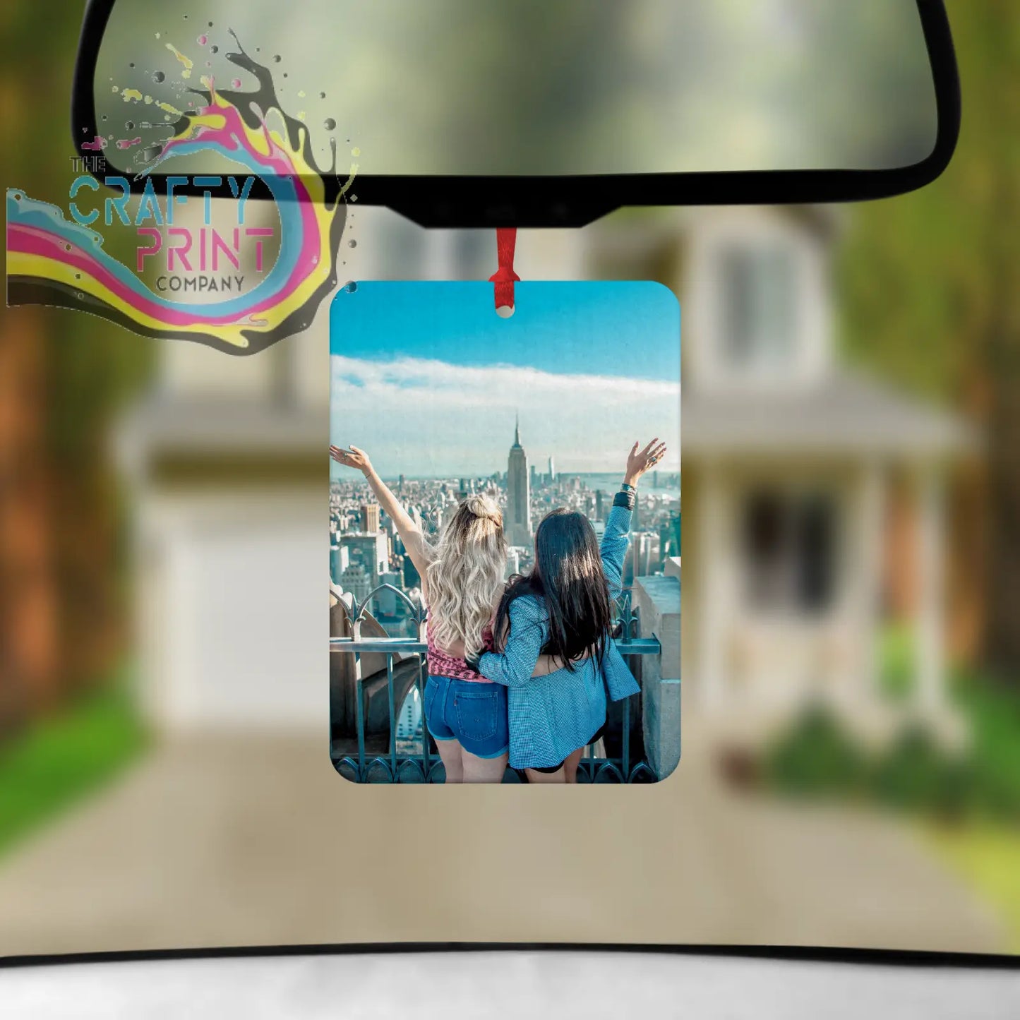 Rectangular test car air fresh featuring vibrant photo of two women with arms raised overlooking city skyline under blue sky
