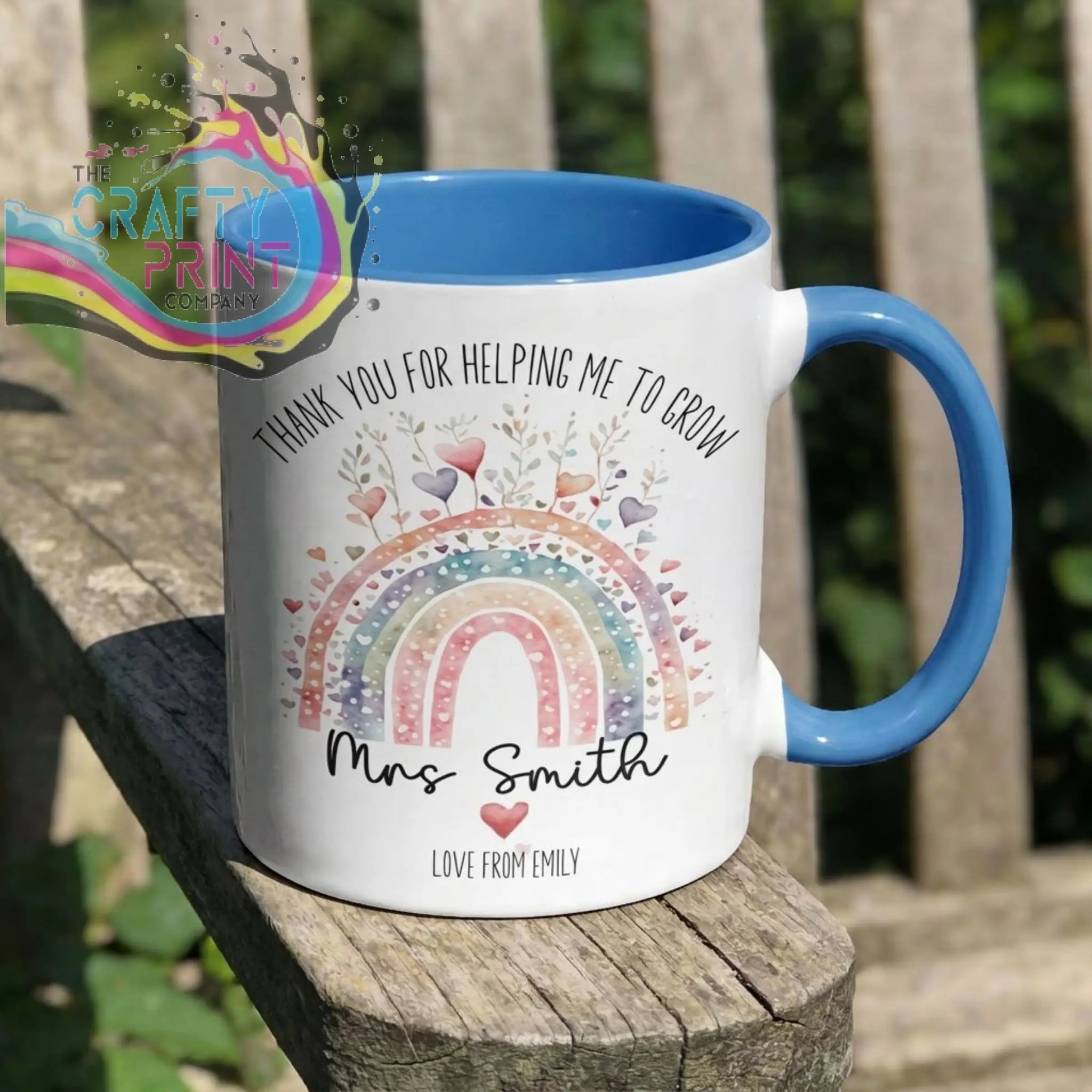 White ceramic grow mug with blue handle and colorful rainbow design featuring thank you message for teacher gifts