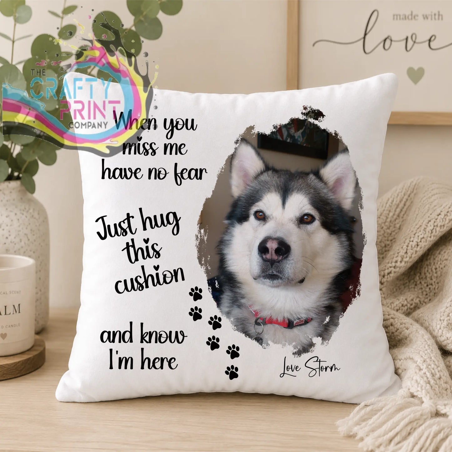 White pet memorial cushion featuring a printed photo of a gray and white alaskan malamute with heartfelt text and paw prints