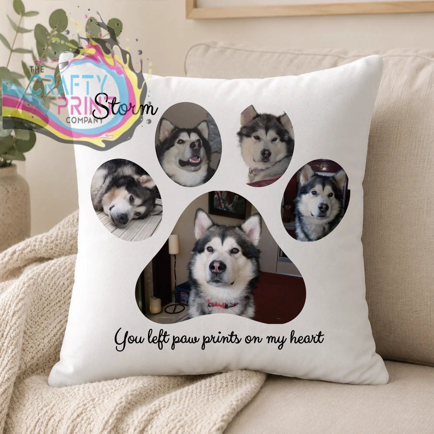 White throw pillow with custom paw print design and photos of an alaskan malamute personalized with storm and left paw prints text
